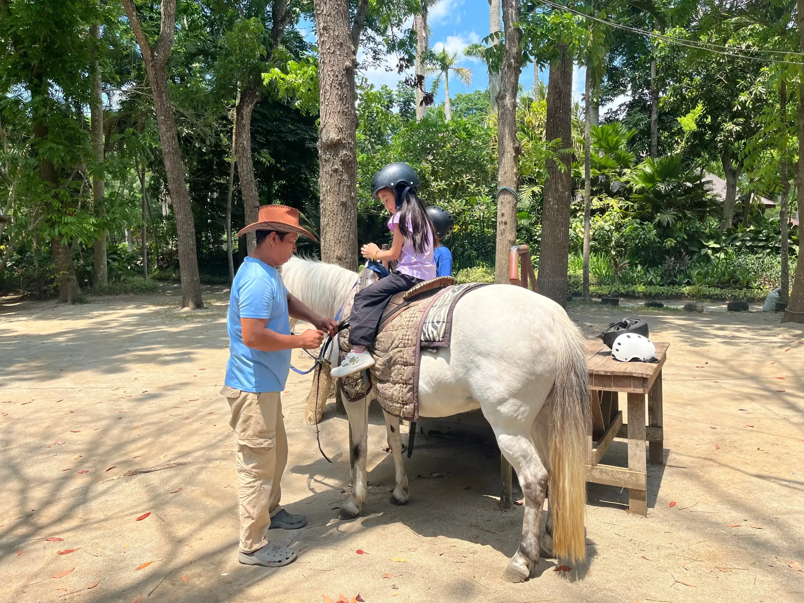 Child riding a horse with guide at The Fun Farm Sta. Elena